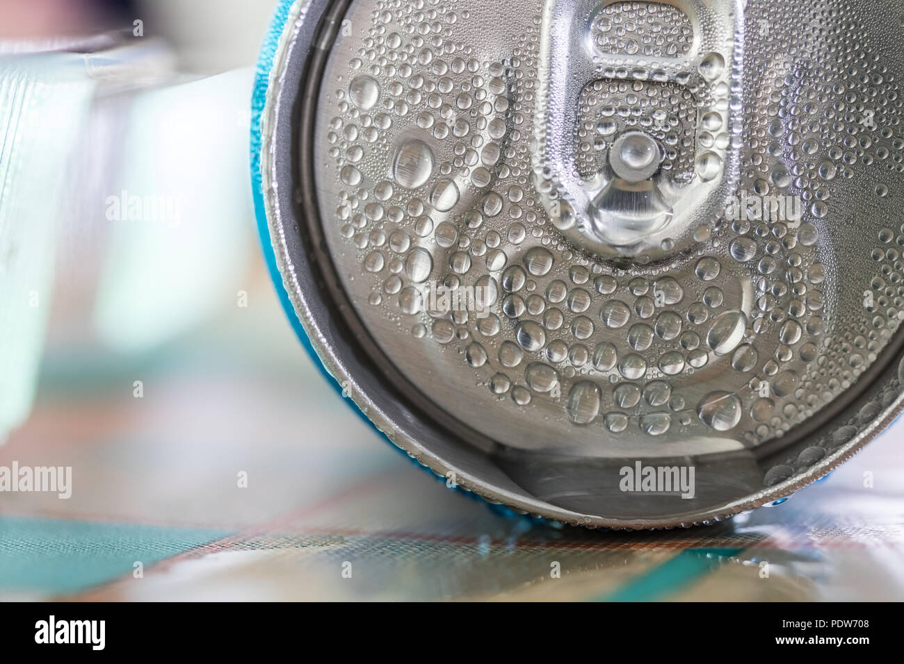 Detail of a can of beverage on a restaurant table. Condensate water