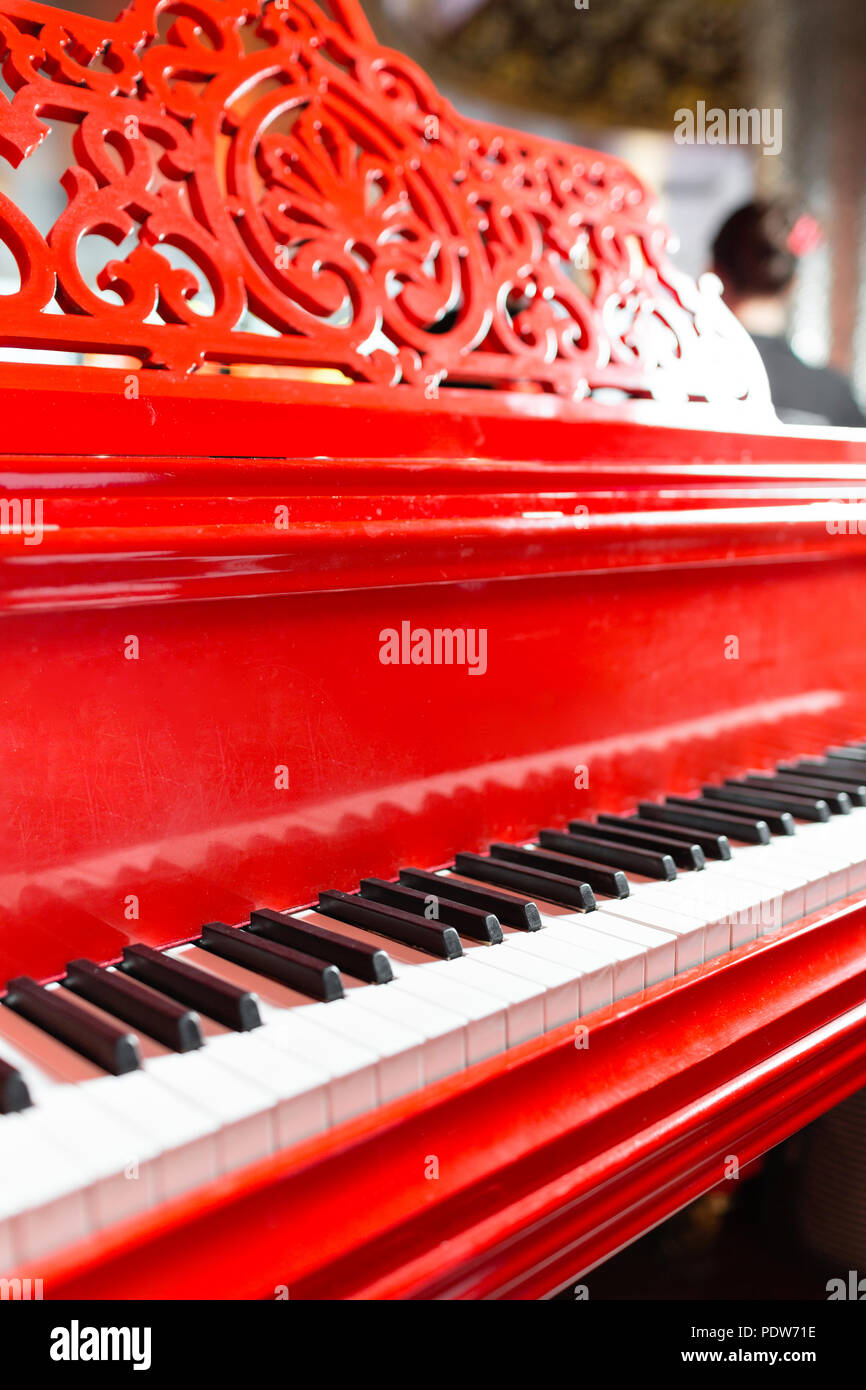 Vintage red classical grand piano. Black and white keys. Keyboard of antique key music instrument. Copy space Stock Photo