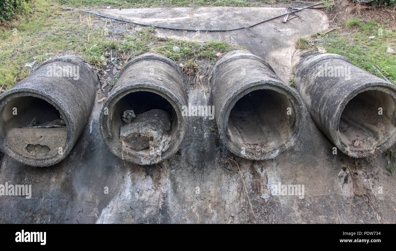 Dry concrete pipes for drainage water on shore. Sewage system. Stock Photo