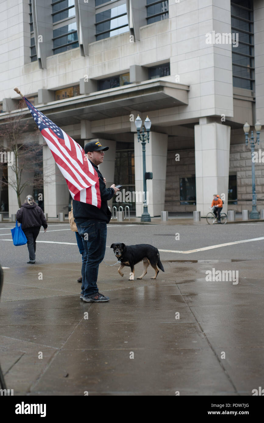 Protester of the second trial of the occupation of the Malheur Wildlife Refuge holding an American flag across from the courthouse. Stock Photo
