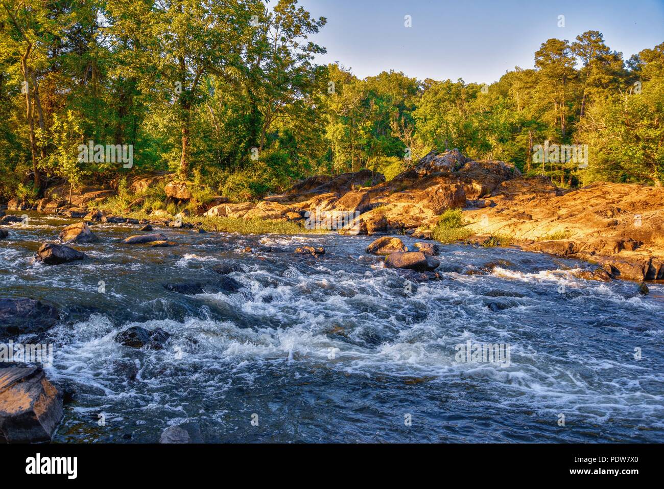 A close up of rocky whitewater off the shore at the Haw River in North