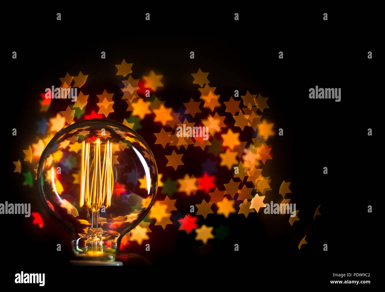 Lighting bulb with beautiful star bokeh background with copy space ...