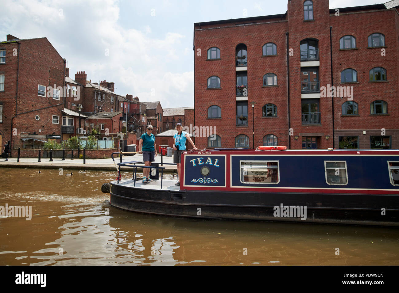 two women on a narrowboat on the Shropshire union canal main line in chester cheshire england uk Stock Photo