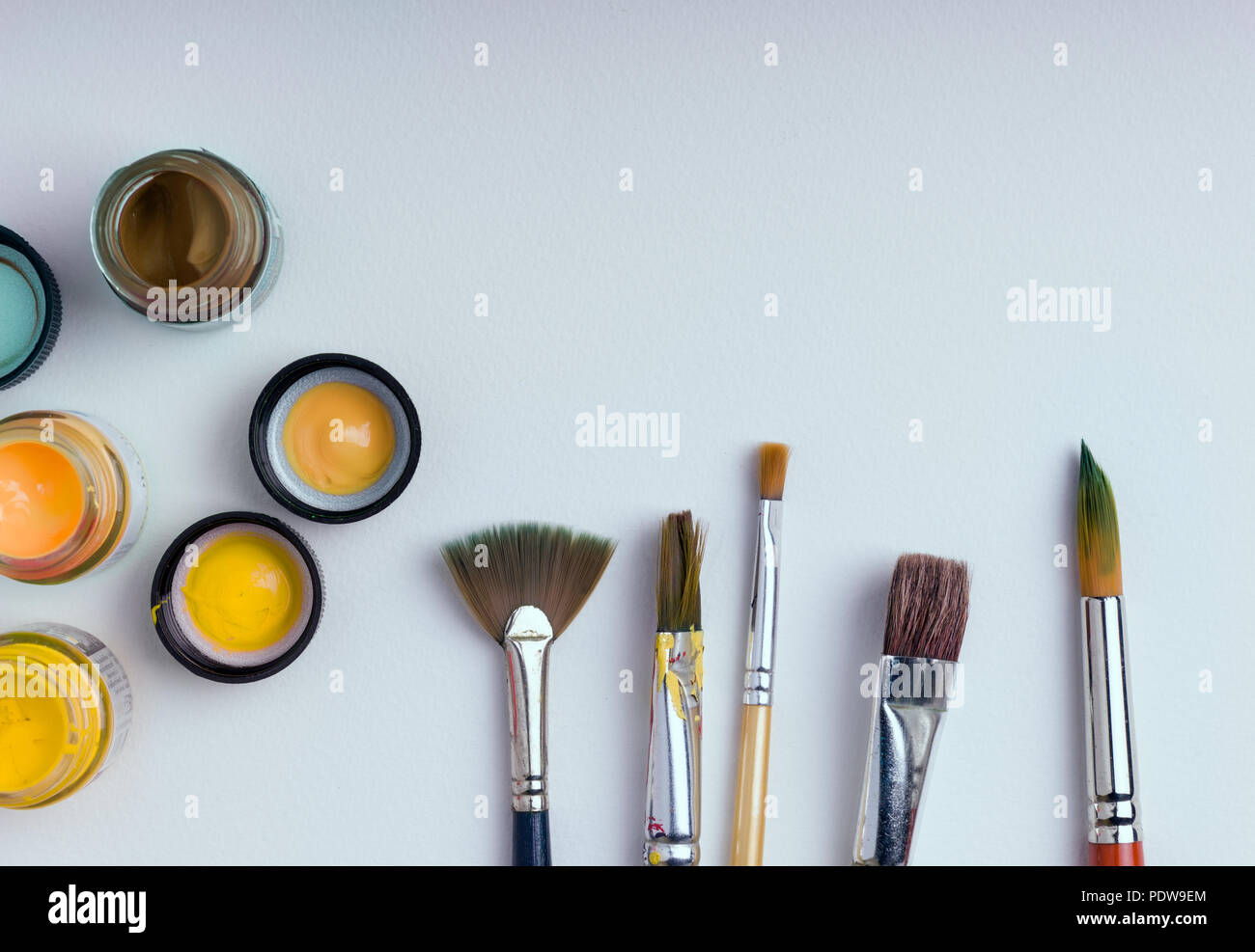 Many brushes for painting on a white background, top view. Stock Photo by  puhimec