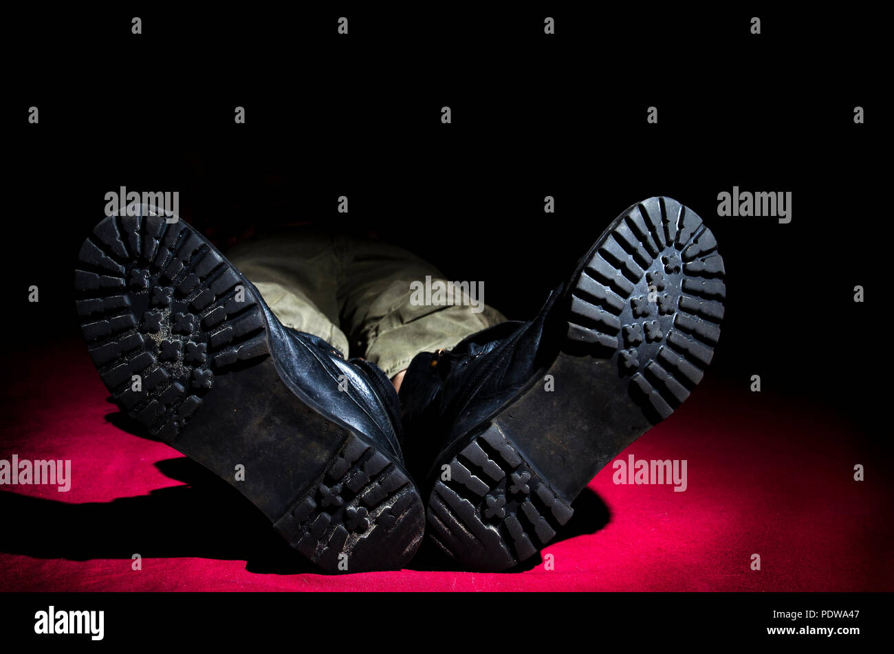 Men's legs in old military boots, lying on the floor Stock Photo Alamy
