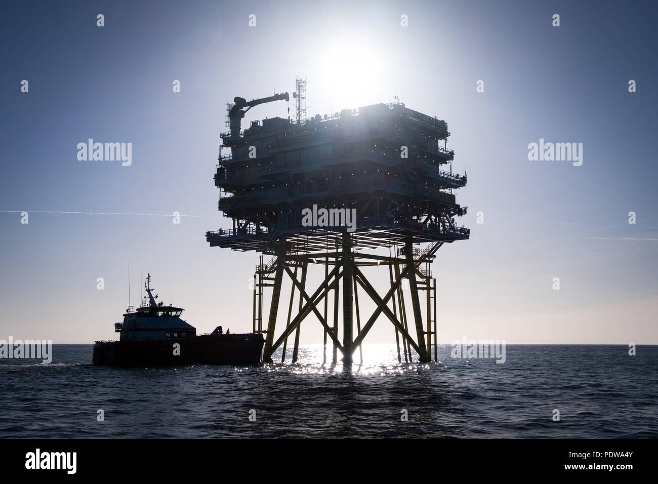 The silhouette of an offshore subsation (Z03) on Walney Extension Offshore Wind Farm in the Irish Sea Stock Photo