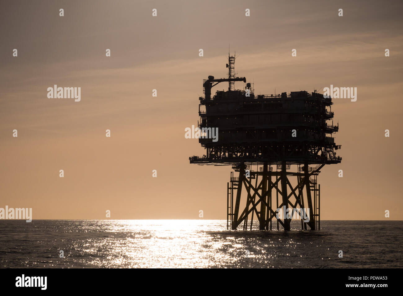 The silhouette of one of two substations on Walney Extension Offshore Wind Farm, the world's largest offshore wind farm Stock Photo