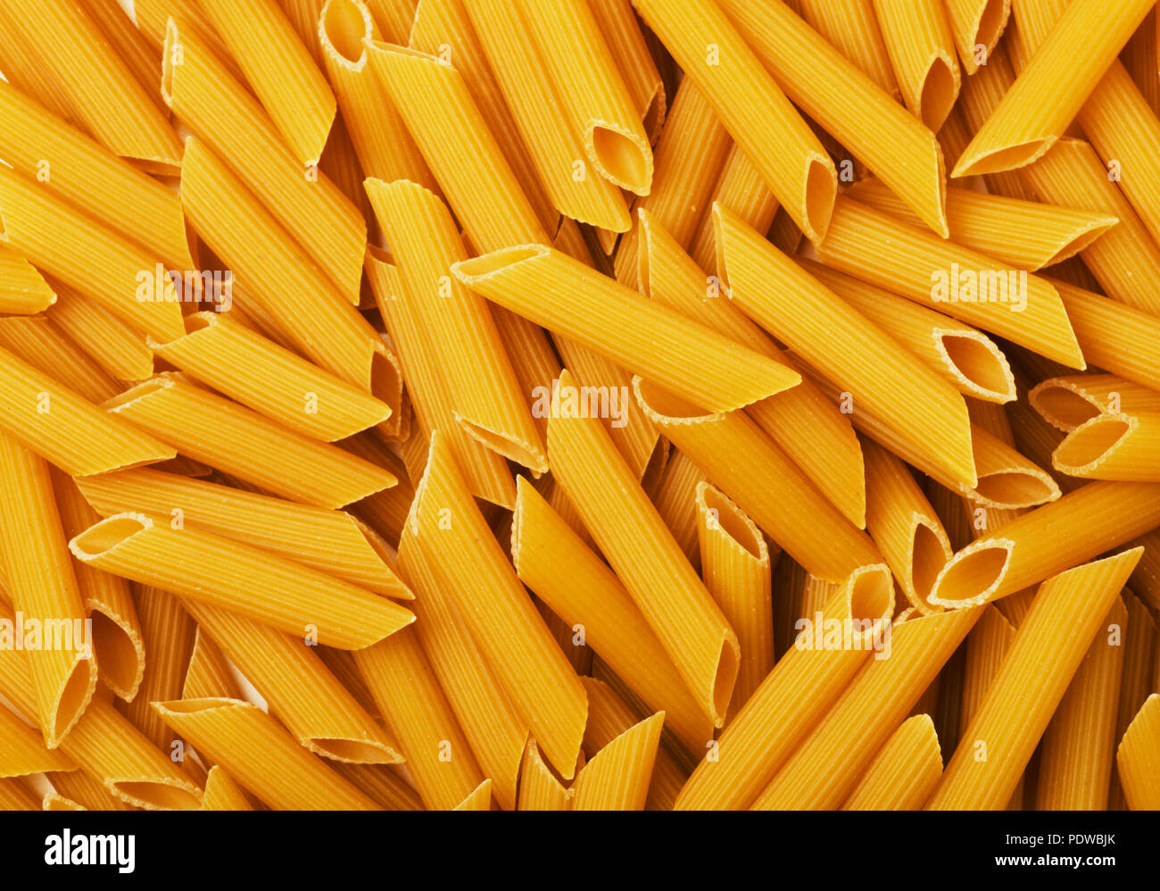 Penne pasta as background Stock Photo - Alamy