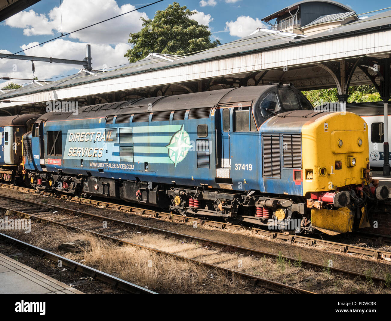 Direct Rail Services class 37 37419 'Carl Haviland' on the Norwich to Lowestoft service August 2018. The train consists of 4 coaches with a class 37 Stock Photo