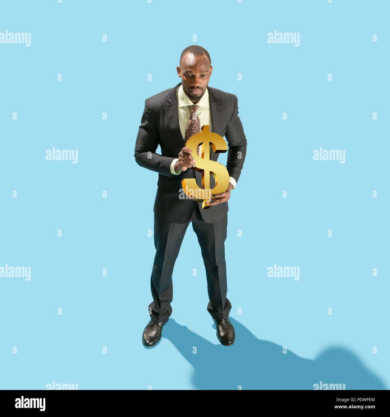 Business man holding dollar sign hi-res stock photography and images ...