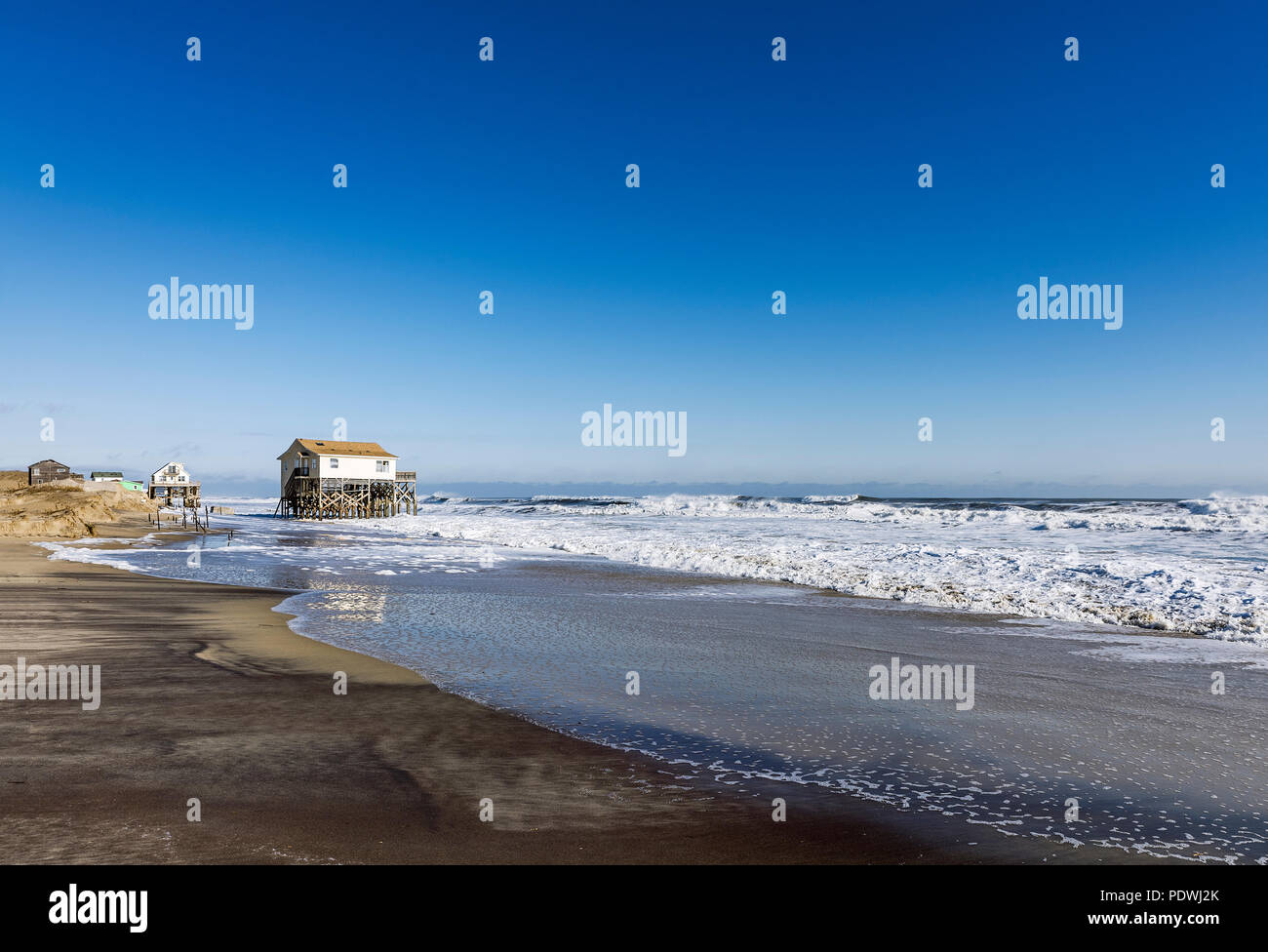 Beach house on stilts surrounded by high tide surf, Nags Head, Outer Banks, North Carolina, USA Stock Photo