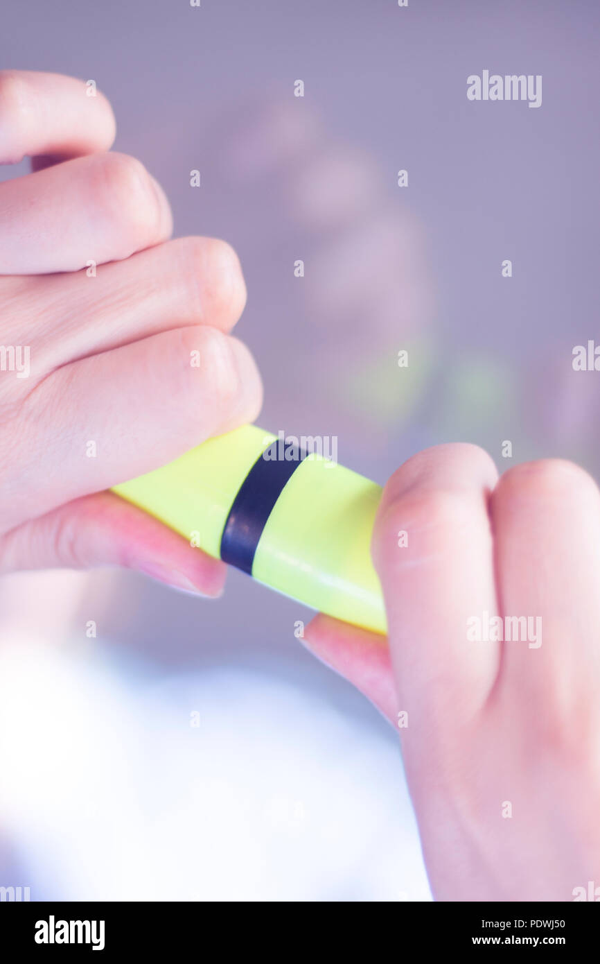 Felt tip permanent highlighter color ink marker pen in hand of young ...