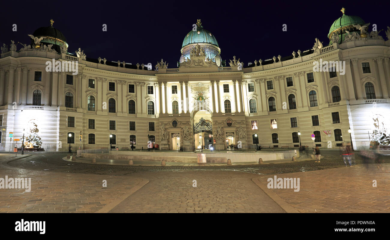 View of Hofburg illuminated at night, the imperial palace of the Habsburgs, from Michaelerplatz Vienna, Austria Stock Photo