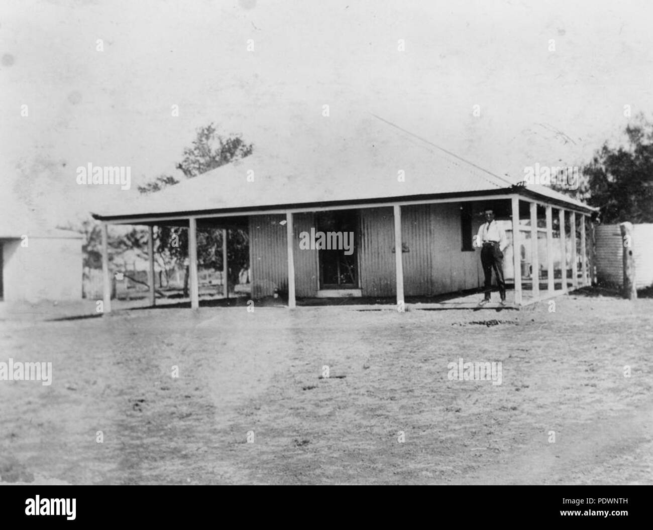 273 StateLibQld 1 77415 Gentleman standing on the verandah of the office at Eddington Station
