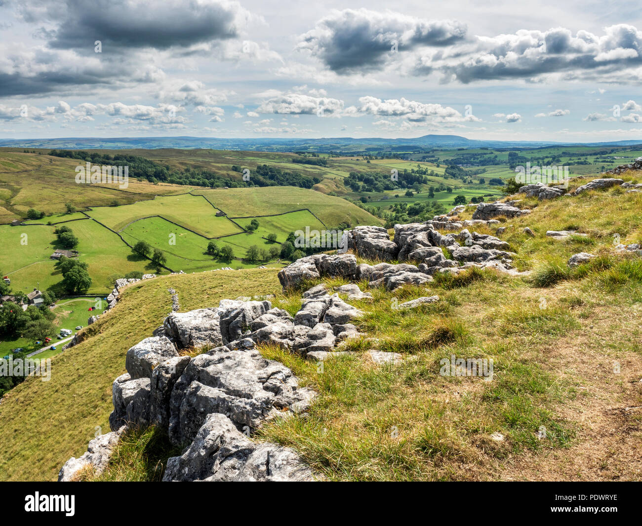 Looking into Malhamdale from a viewpoint above Gordale Scar with Pendle Hill on the horizon Yorkshire Dales England Stock Photo