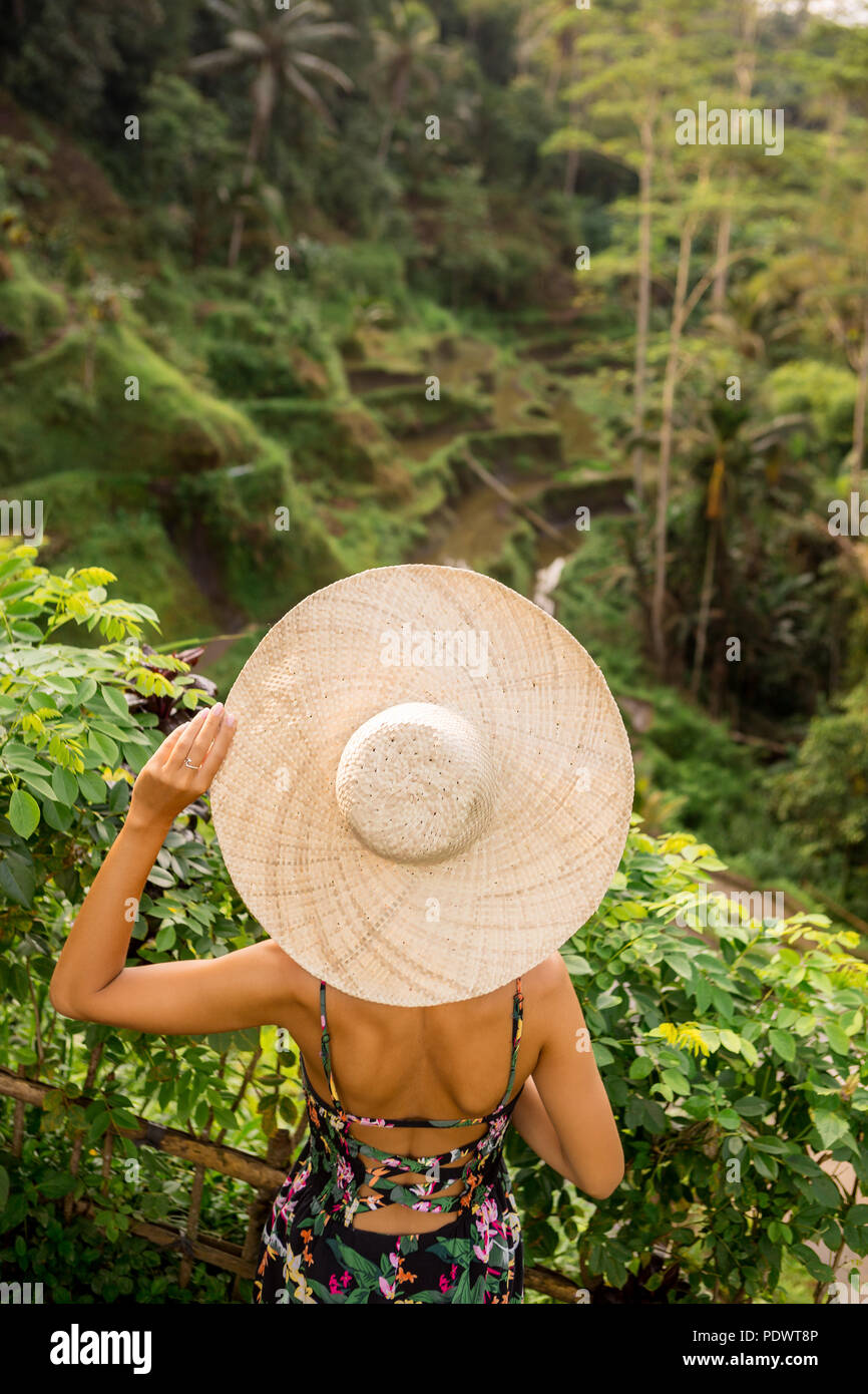 Beautiful young woman in straw hat 