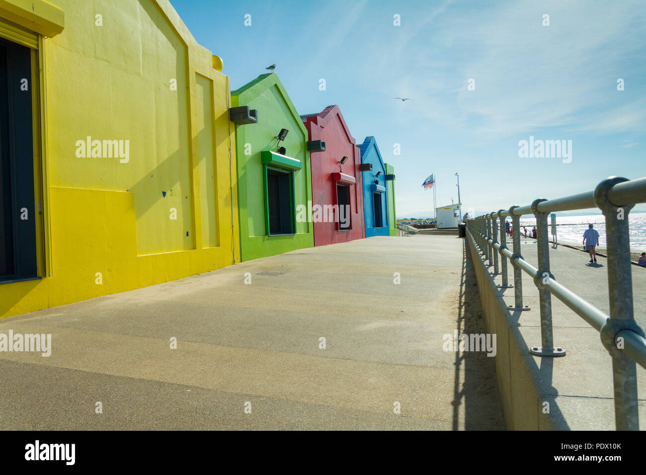 Colourful seaside buildings along the promenade at Central Beach, Prestatyn, Wales, UK, on a very sunny day during the 2018 heatwave. Stock Photo