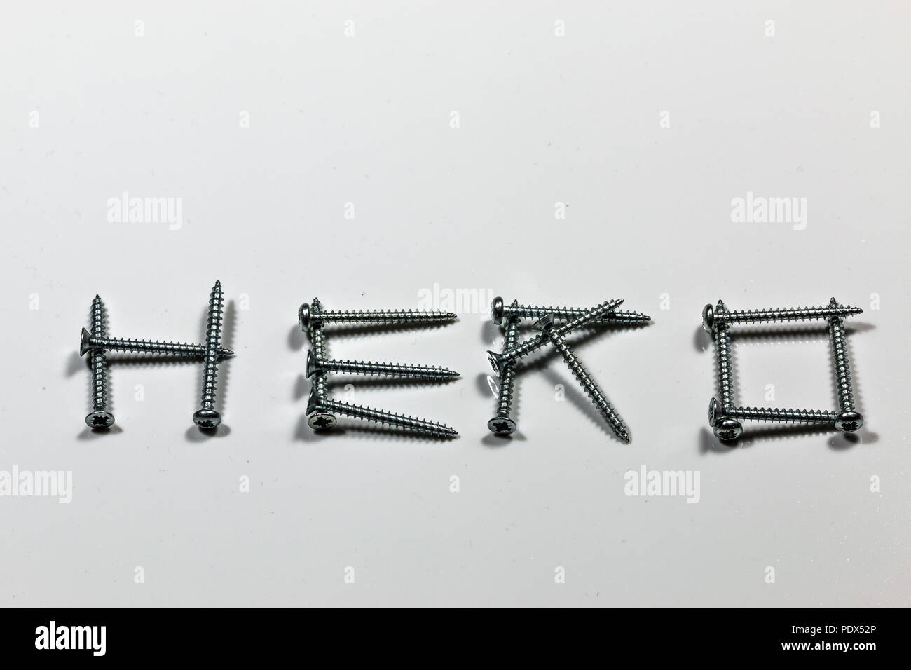 The word HERO written with screws on white background Stock Photo