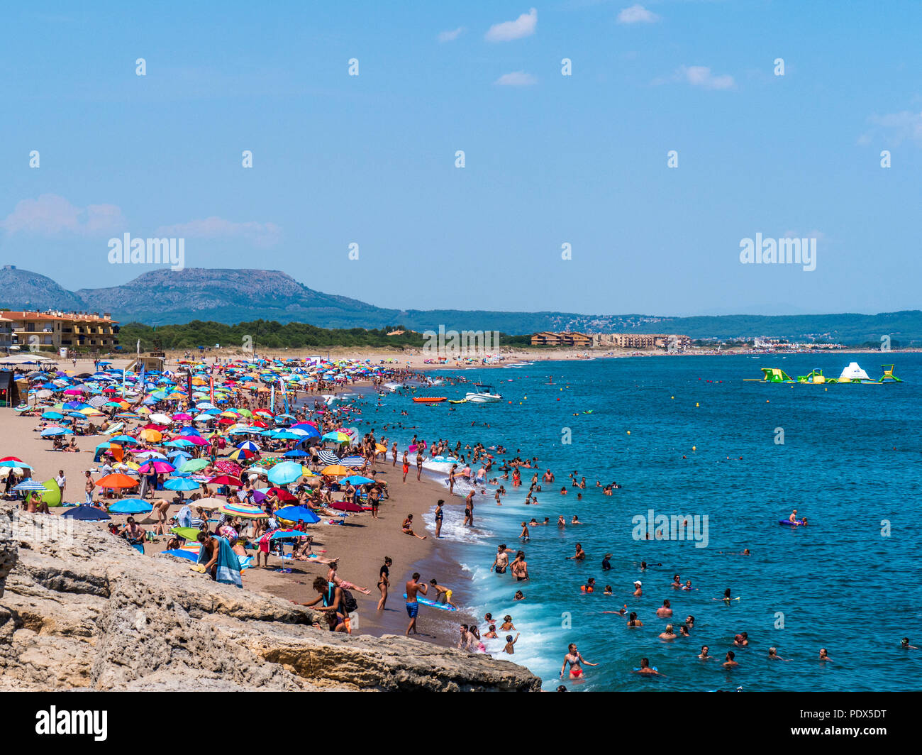 Costa Brava Spain, Aug 3 2018: People flock to the beach to avoid summer heat in Pals Beach in Costa Brava Spain Stock Photo