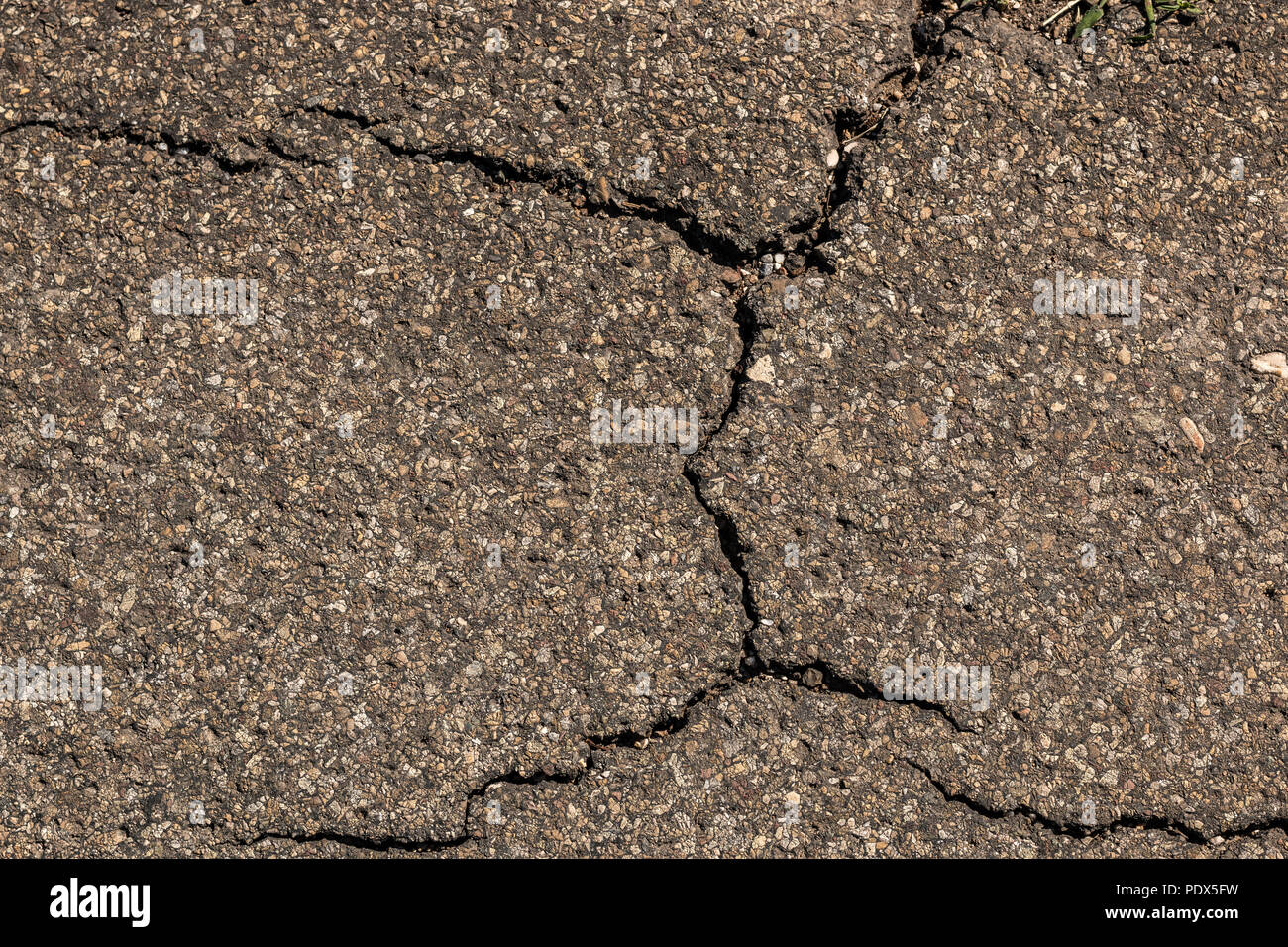 Cracks on the ground of the road Stock Photo