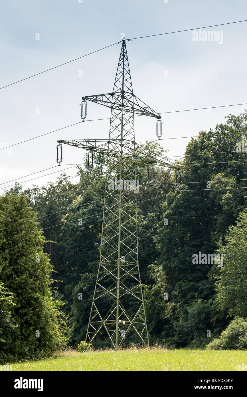 Power pylon on the green field Stock Photo