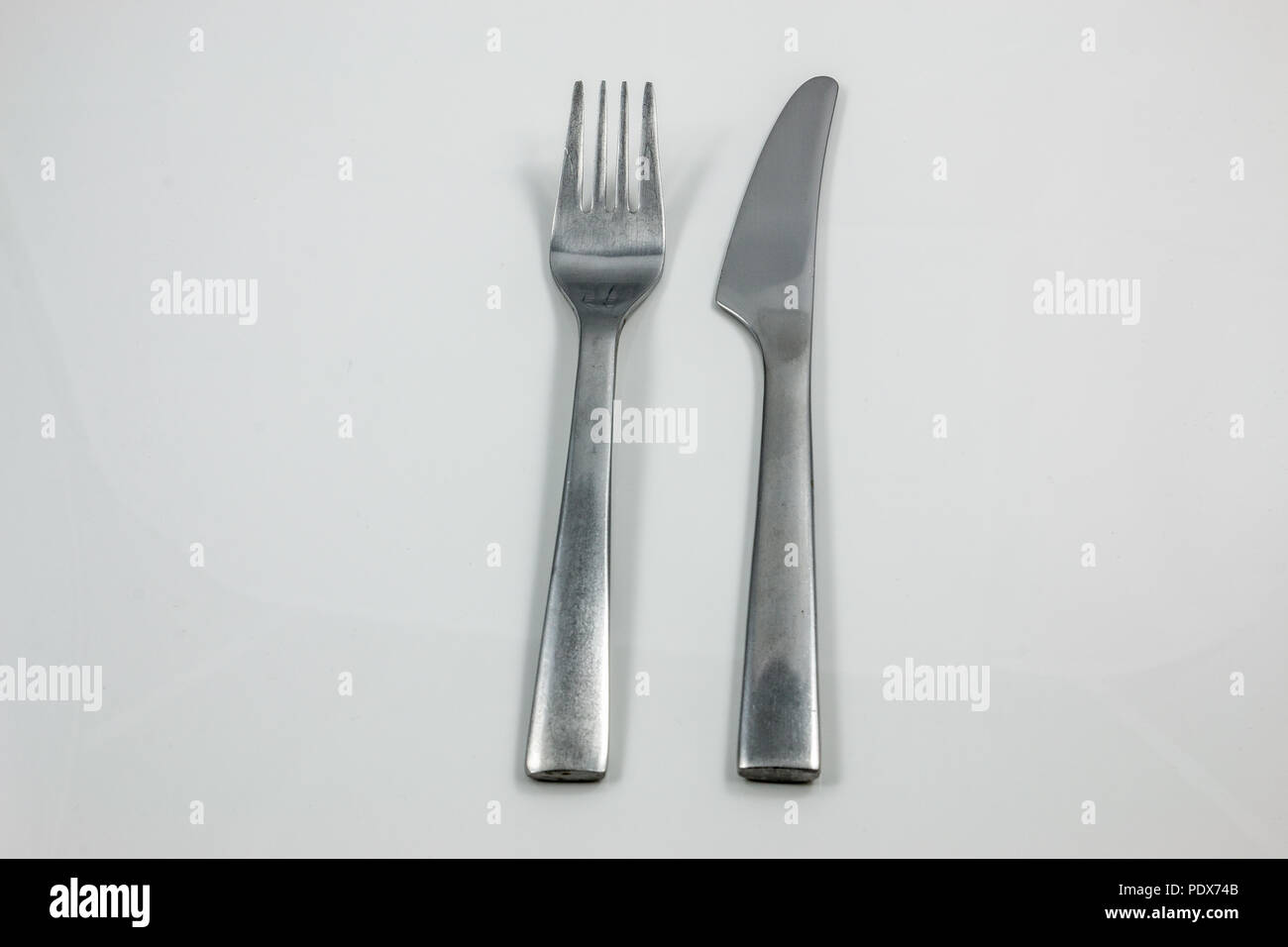Steel cutlery with knife and fork Stock Photo