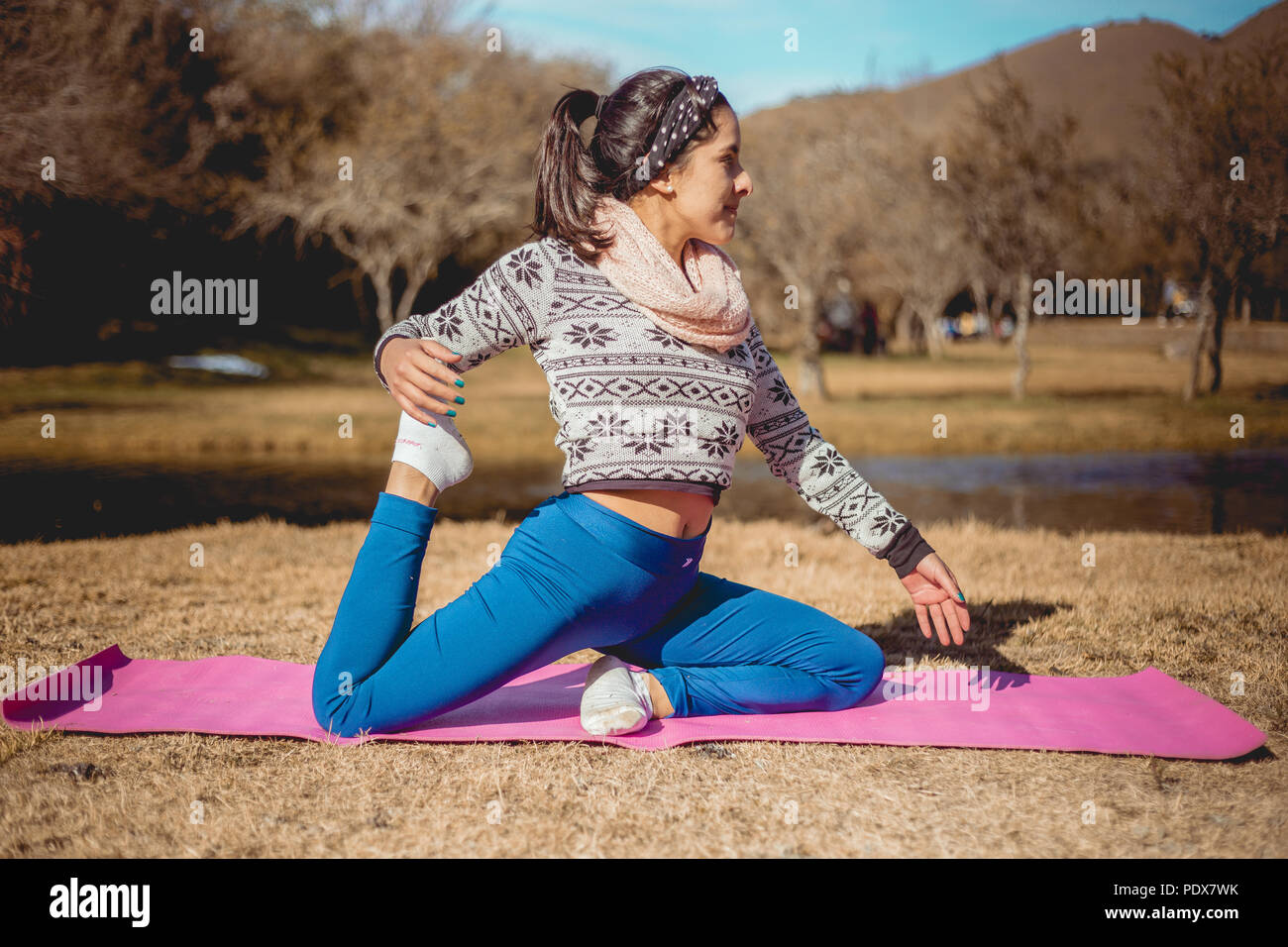 Girl doing Yoga in park Stock Photo