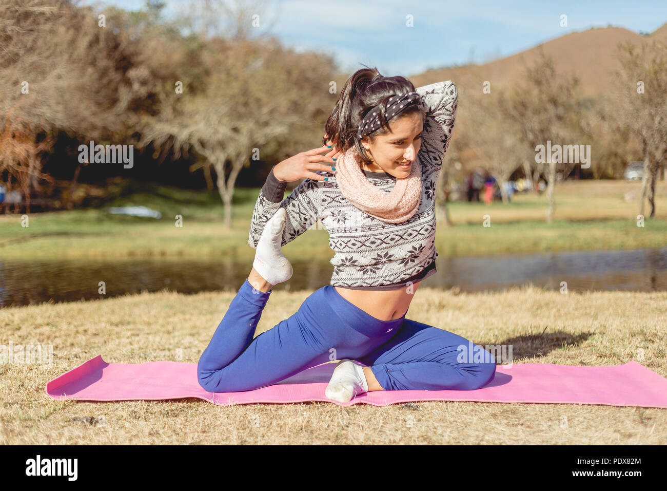 Girl doing Yoga in park Stock Photo