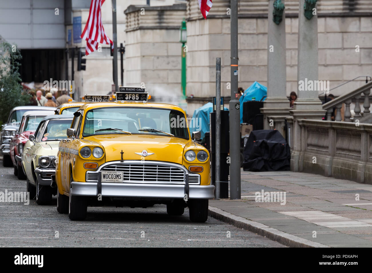 Vintage Washington DC yellow taxi cab photographed in Liverpool UK whilst being filmed as part of a major TV series. Stock Photo