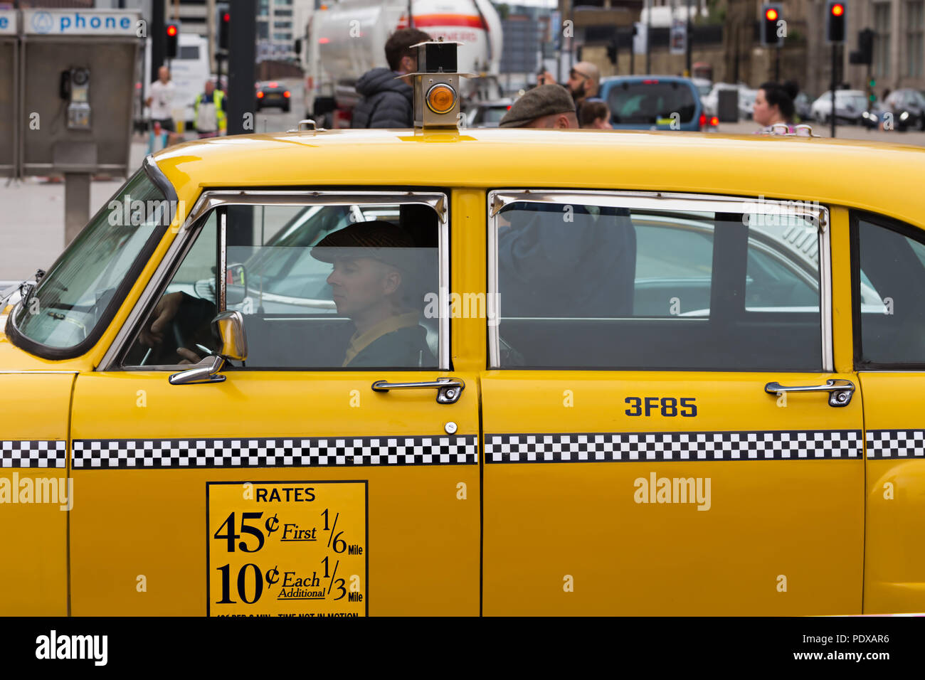 Vintage Washington DC yellow taxi cab photographed in Liverpool UK whilst being filmed as part of a major TV series. Stock Photo