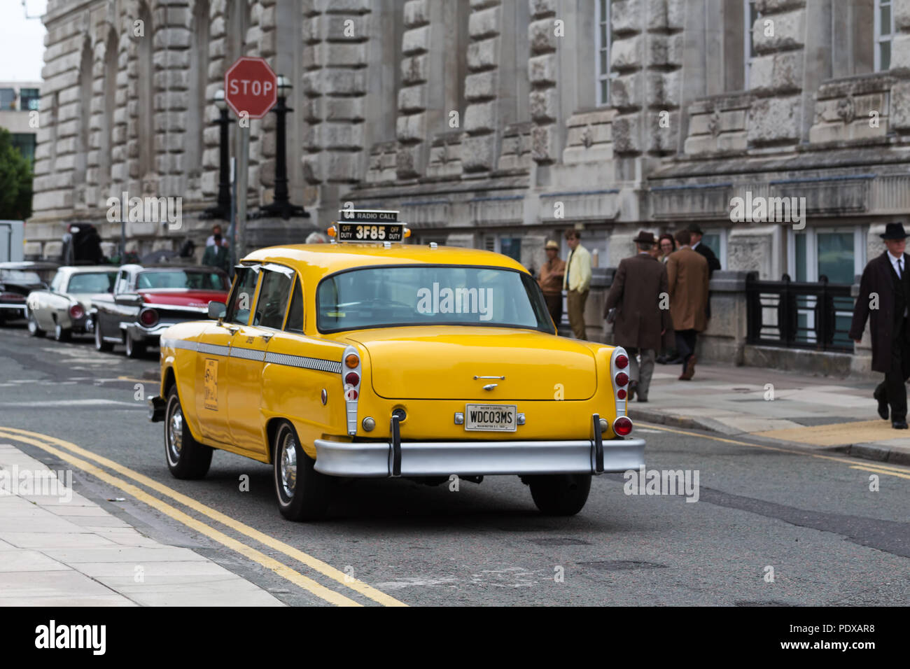 Vintage Washington DC yellow taxi cab photographed in Liverpool UK whilst being filmed as part