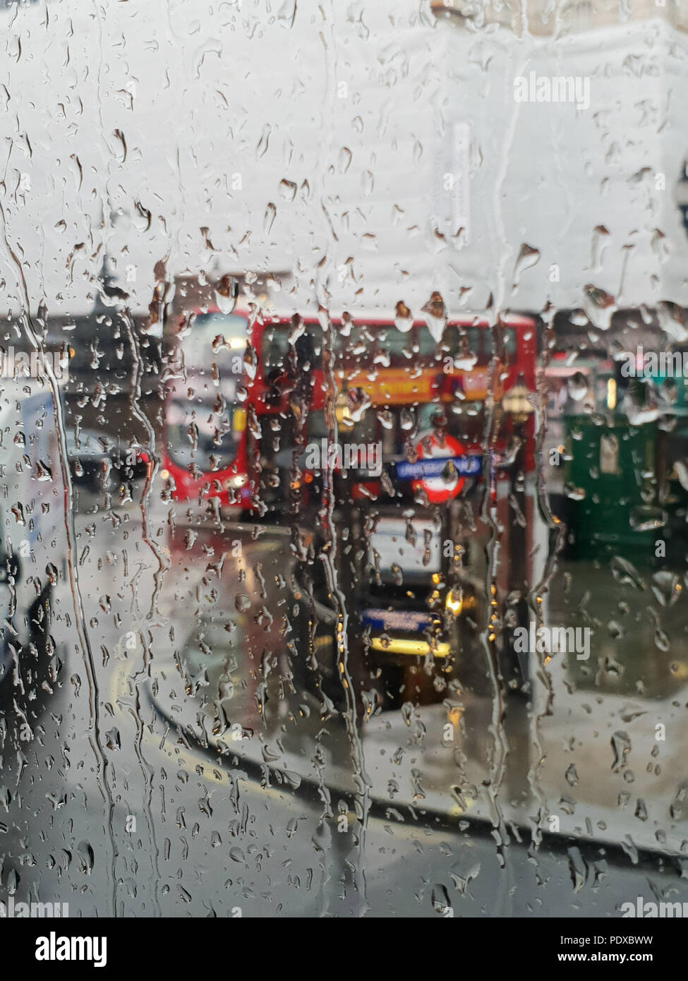 Regents Street. London. UK 10 Aug 2018 - View of London's Regent Street and red double decker bus through a bus window during heavy rainfall in central London.   Credit Roamwithrakhee /Alamy Live News Stock Photo