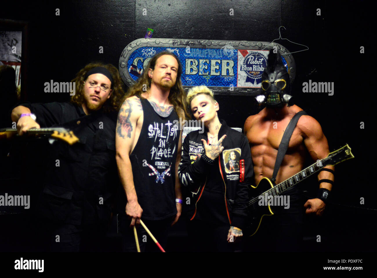 West Hollywood, CA, USA. 8th Aug, 2018. Musicians - [left to right] DREWSKI BARNES bass player, JUSTIN KIER drums, OTEP SHAMAYA lead vocals, and ''ARISTOTLE'' ARI MIHALOPOULOS guitarist for OTEP, back stage at The Whisky A Go Go, West Hollywood, California, USA, August 8, 2018. OTEP is a Los Angeles based heavy metal band that integrates rap metal, new metal, alternative metal into their sound. OTEP is an anagram for poet. Otep Shamaya descibes the bands sound as, ''art house nu-metal.'' .Image Credit cr Scott Mitchell/ZUMA Press Credit: Scott Mitchell/ZUMA Wire/Alamy Live News Stock Photo