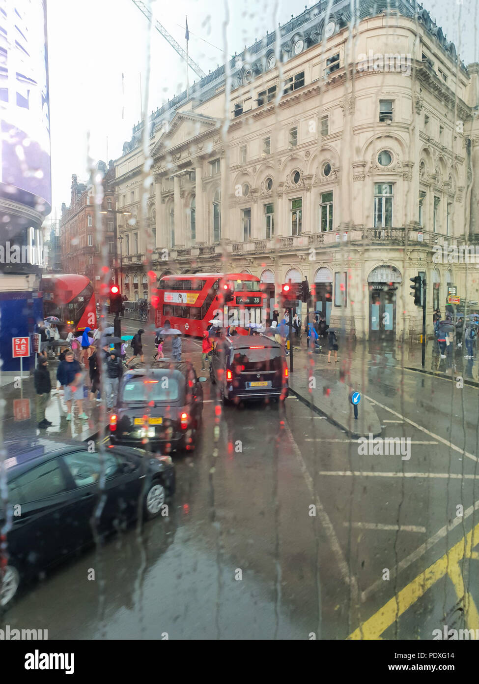 Westminster. London. UK 10 Aug 2018 - View of Piccadilly Circus through a double decker bus window covered with raindrops.  Credit Roamwithrakhee /17�Թ����� Live News Stock Photo