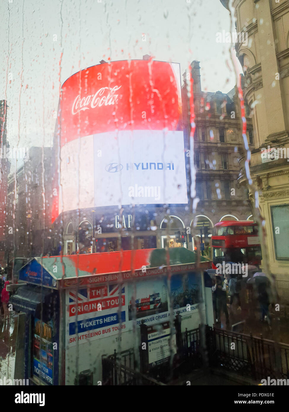 Westminster. London. UK 10 Aug 2018 - View of Piccadilly Circus through a double decker bus window covered with raindrops.  Credit Roamwithrakhee /17�Թ����� Live News Stock Photo
