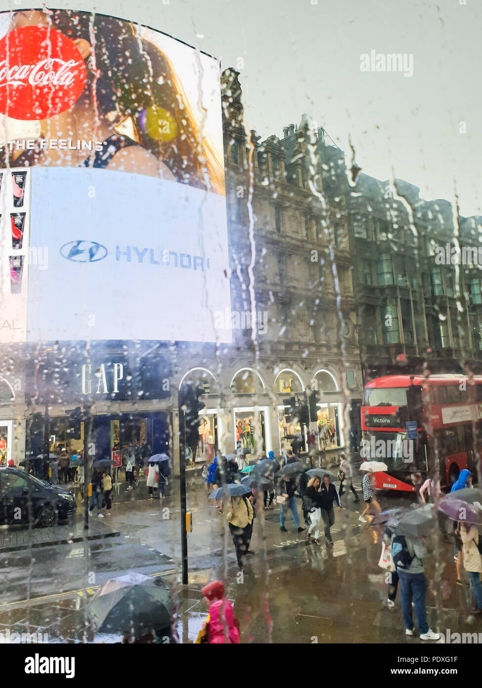 Westminster. London. UK 10 Aug 2018 - View of Piccadilly Circus through a double decker bus window covered with raindrops.  Credit Roamwithrakhee /17�Թ����� Live News Stock Photo