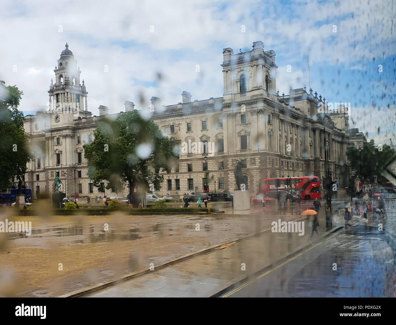 Westminster. London. UK 10 Aug 2018 - View of Parliament Square through a double decker bus window covered with raindrops.  Credit Roamwithrakhee /17�Թ����� Live News Stock Photo