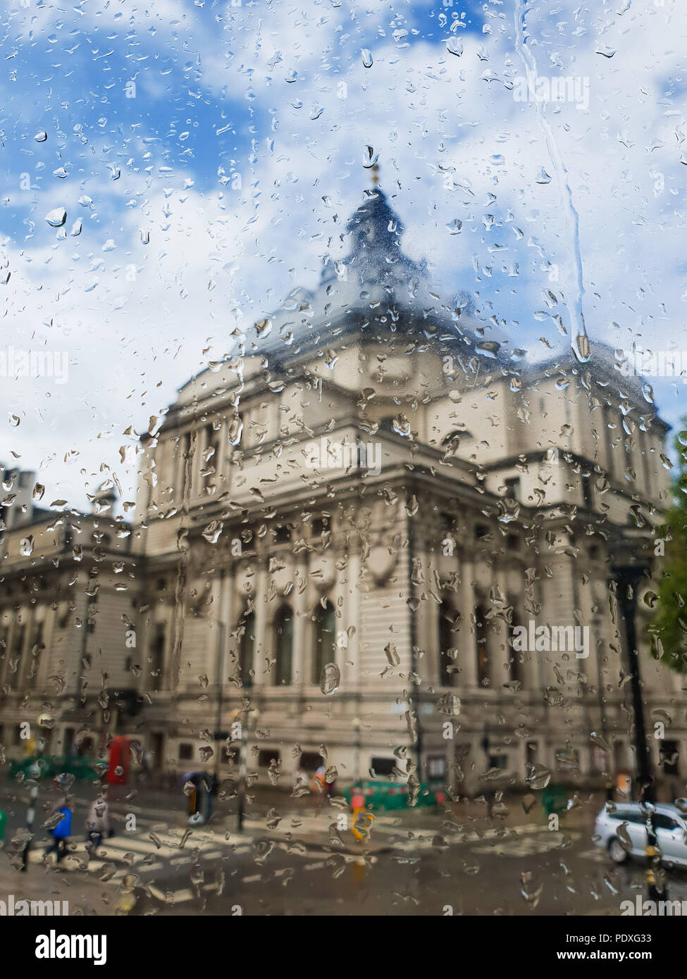 Westminster. London. UK 10 Aug 2018 - View of Methodist Central Hall through a double decker bus window covered with raindrops.   Credit Roamwithrakhee /17�Թ����� Live News Stock Photo
