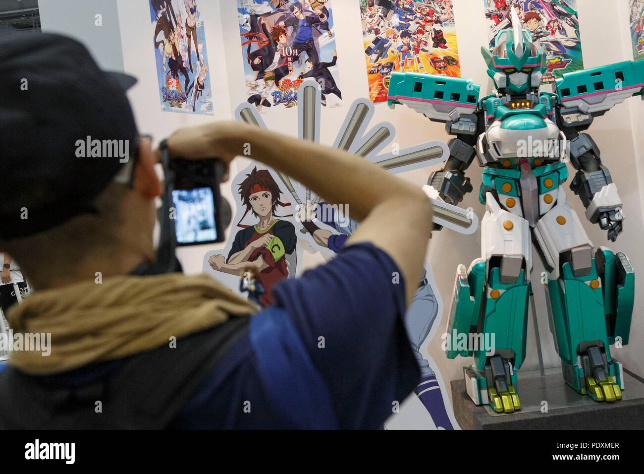 Tokyo, Japan, 11 Aug 2018. A man takes a picture of a bullet train robot during the Comic Market 94 (Comiket) event at Tokyo Big Sight on August 11, 2018, Tokyo, Japan. The annual event that began in 1975 focuses on manga, anime, game and cosplay. Organizers expect more than 500,000 visitors to attend the 3-day event. Credit: Rodrigo Reyes Marin/AFLO/Alamy Live News Stock Photo