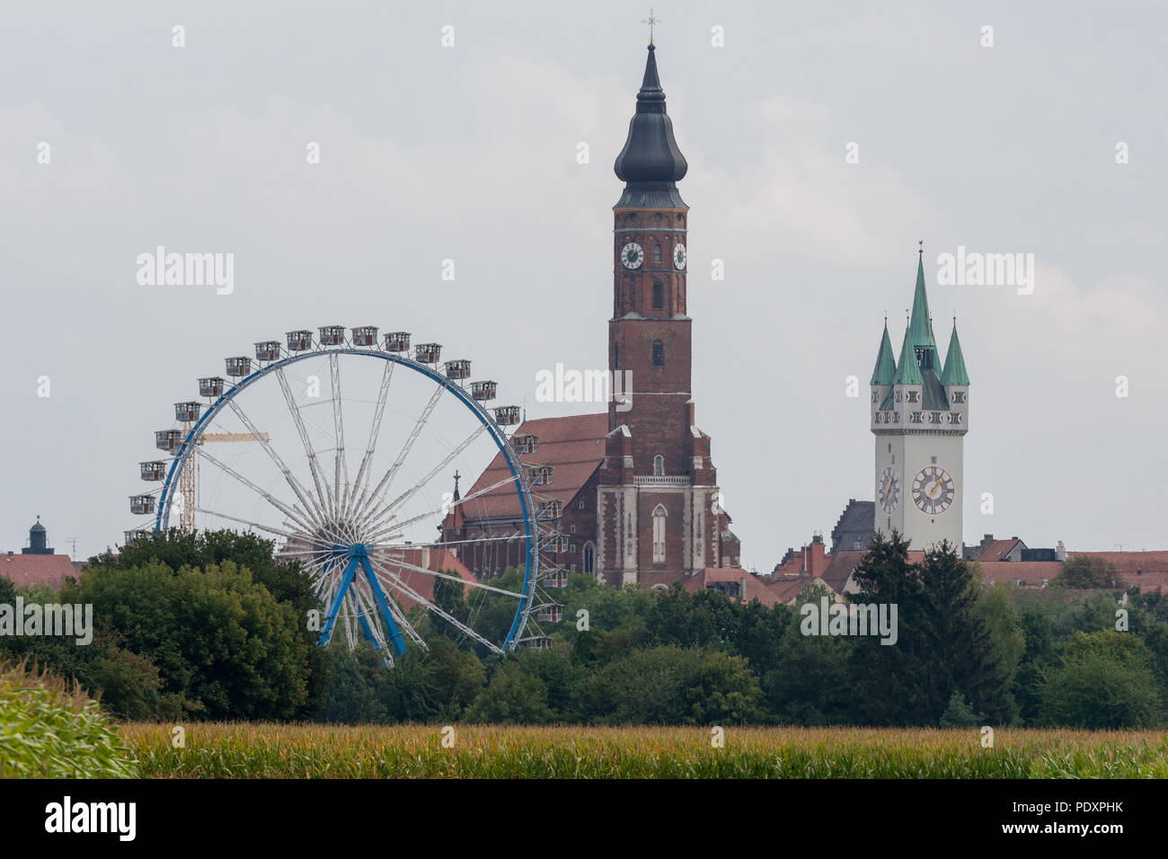 Straubing, Germany. 11th Aug, 2018. The Ferris wheel of the Gaeuboden Folk Festival stands in front of the city scenery with the water tower of the Basilica St. Jakob and the city tower. Credit: Armin Weigel/dpa/Alamy Live News Stock Photo