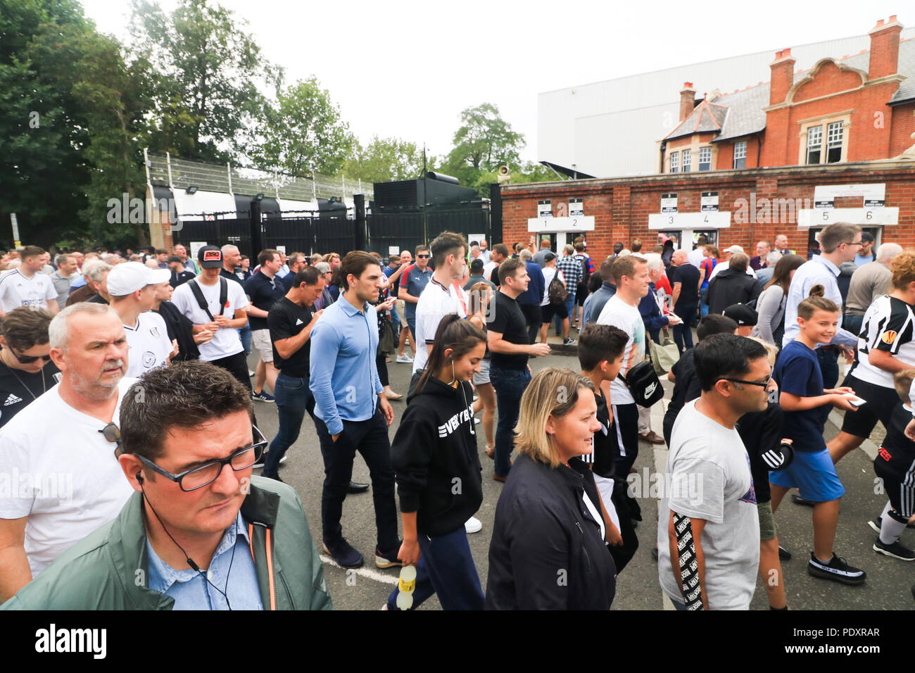 London UK. 11th August 2018. Thousands of Fans arrive at the Craven Cottage stadium in West London on the opening day of the English Premier League match between Fulham"Cottagers and Cyrstal Palace 'Eagles" Stock Photo