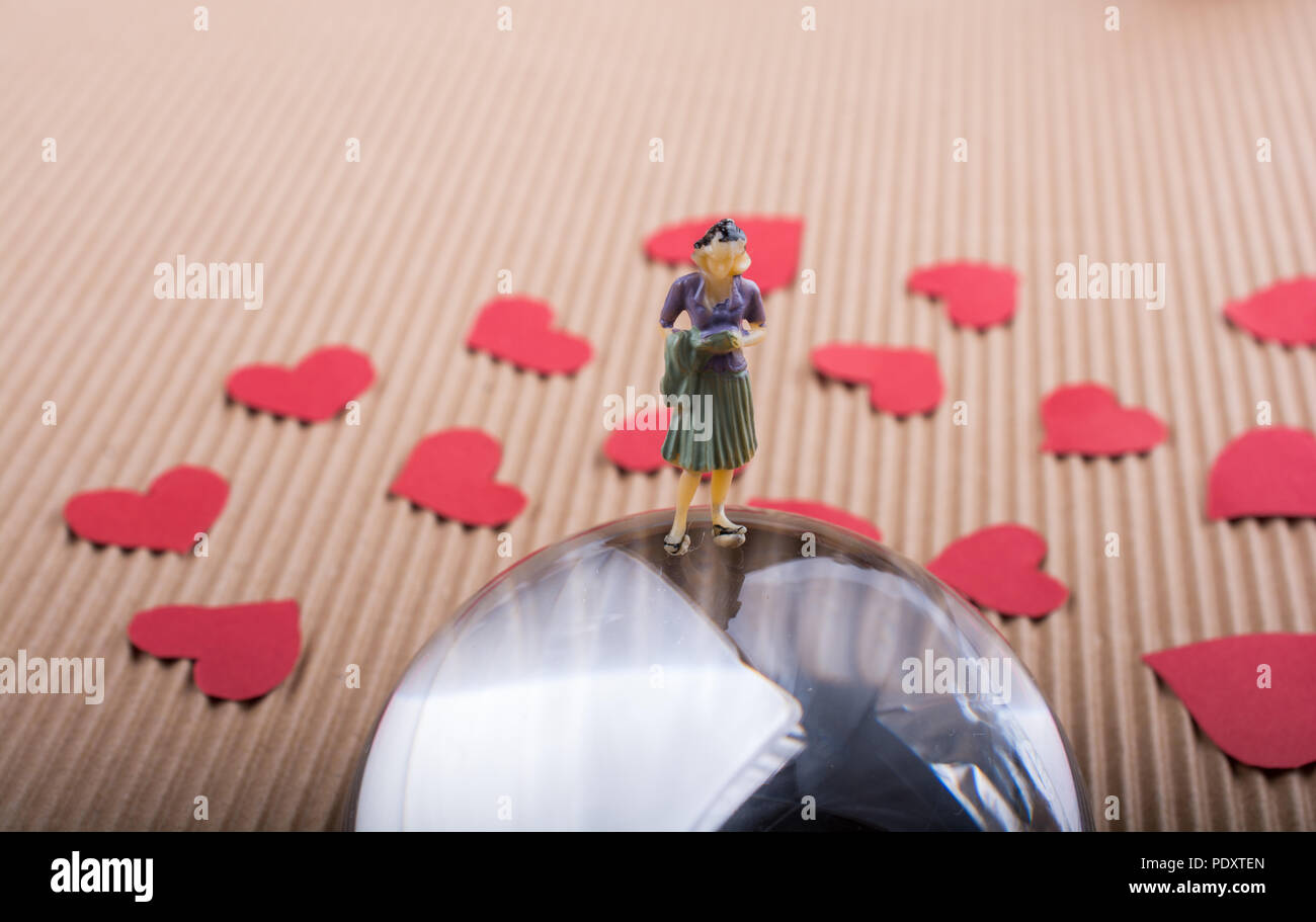 Woman figurine and Love concept with red paper hearts Stock Photo - Alamy