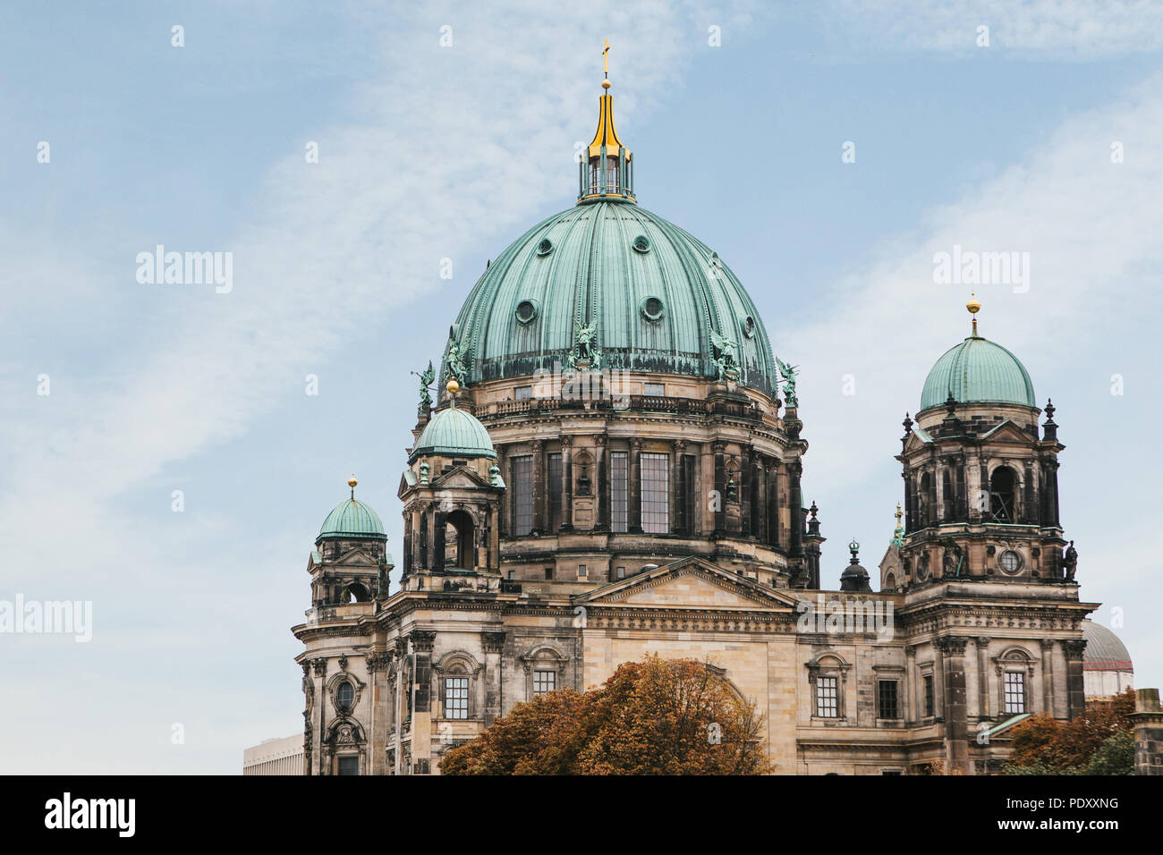 The Berlin Cathedral is called Berliner Dom against the blue sky. Beautiful old building in the style of neoclassicism and baroque with cross and scul Stock Photo