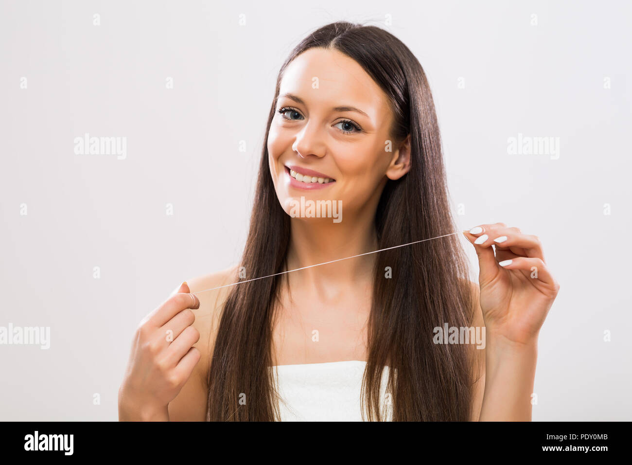 Image of beautiful woman showing dental floss Stock Photo Alamy