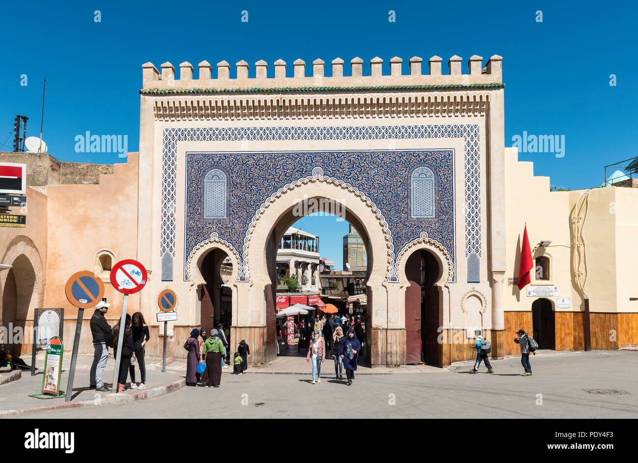 Locals and tourists in front of Bab Boujeloud, Blue Gate of Fes, Minaret of the madrasa Madrasa Bou Inania, Medina of Fez Stock Photo