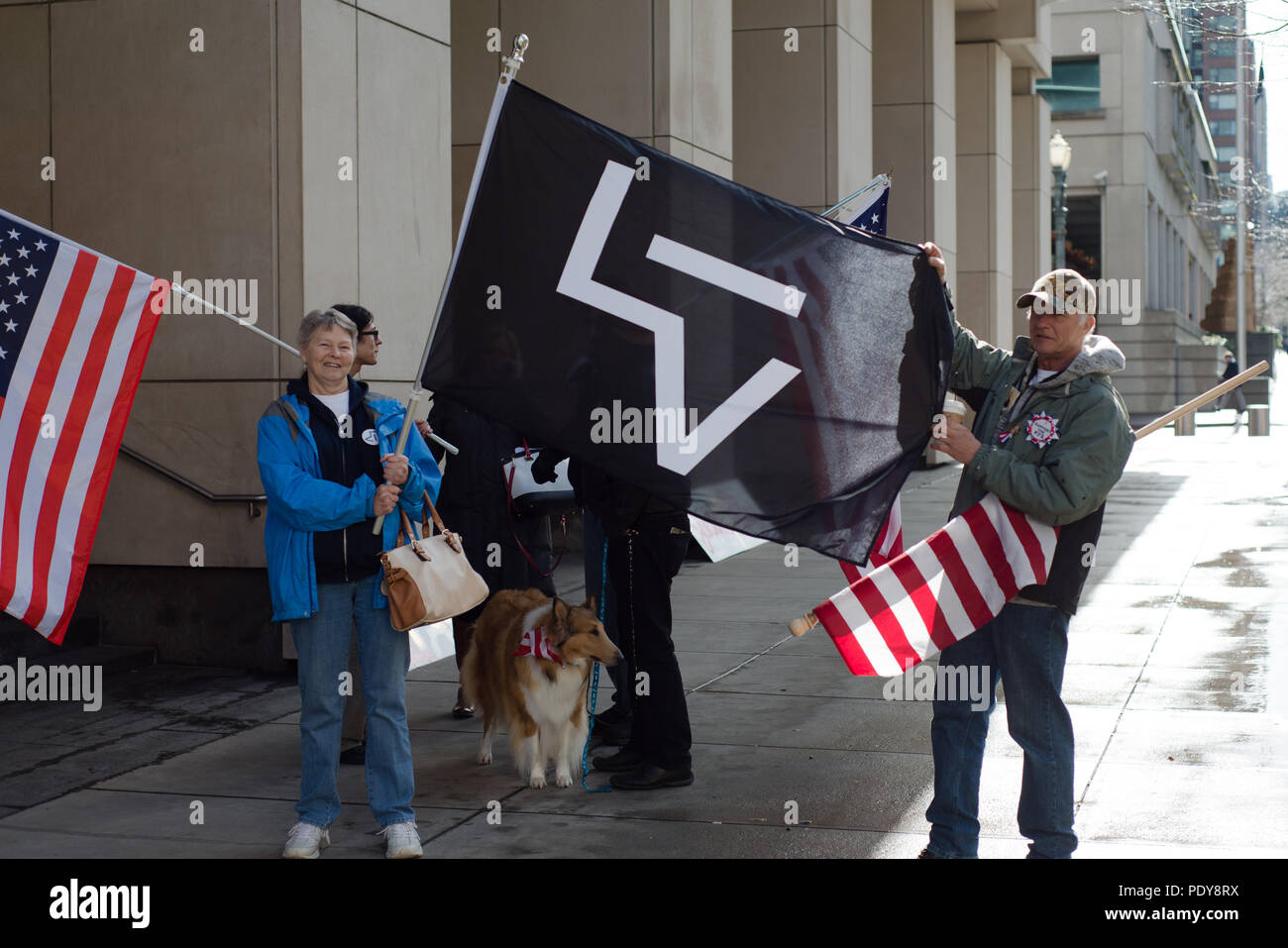 A couple holding a flag protesting the second trial of participants of the occupation of the Malheur Wildlife Refuge and the death of LaVoy Finicum. Stock Photo
