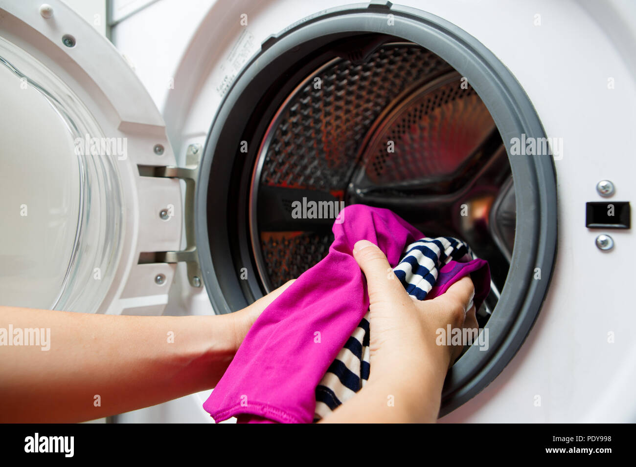 Photo Of Female Hands Folding Colorful Things In Washing