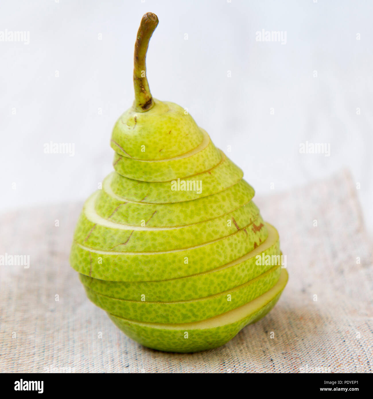 Sliced fresh pear on cloth, closeup. Side view. Stock Photo