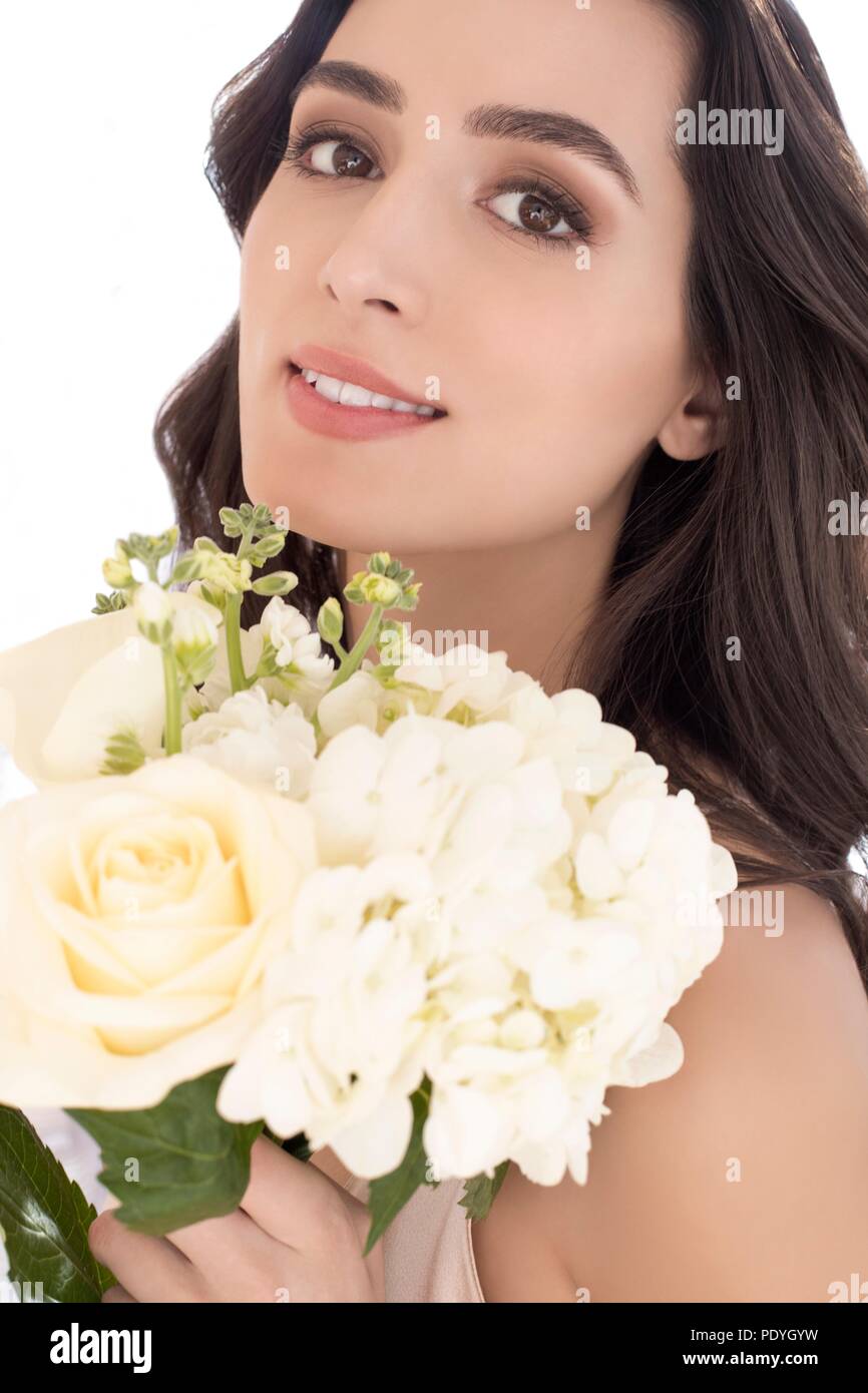 Young woman holding white flowers, portrait. Stock Photo