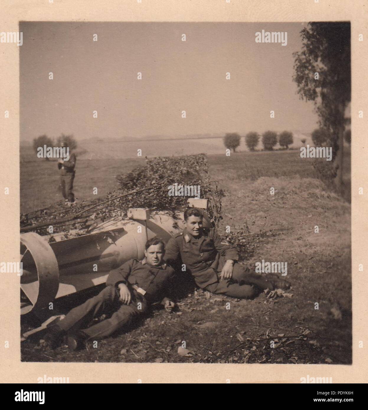 Image from the photo album of Feldwebel Willi Hoffmann of 5. Staffel, Kampfgeschwader 30: Gefreiter Willi Hoffmann and a comrade from 5./KG 30 relax beside a 500kg bomb, May 1940. Stock Photo